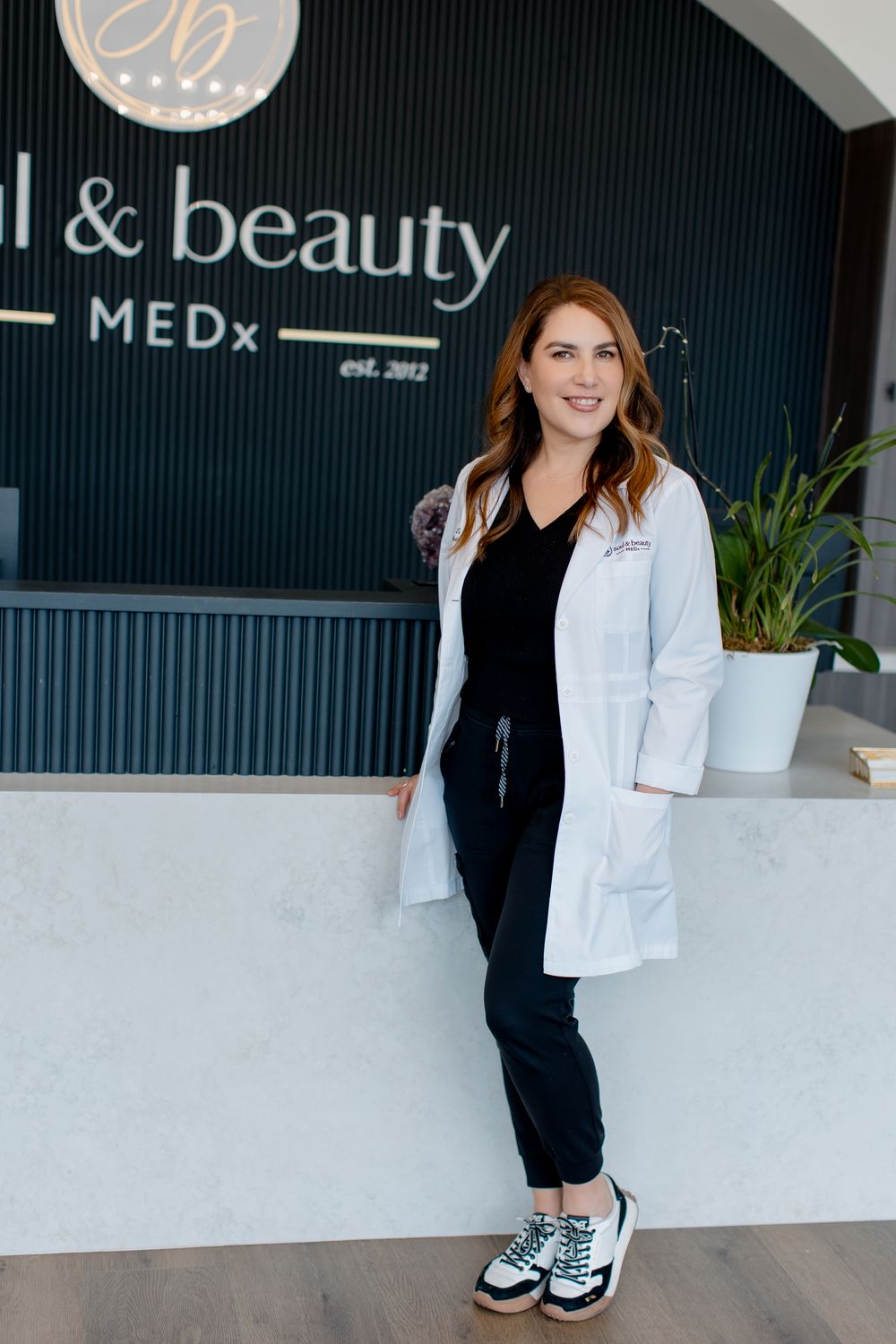 Linda Rank, PA-C, at reception desk of soul&beautyMEDx, Orange County Med Spa.