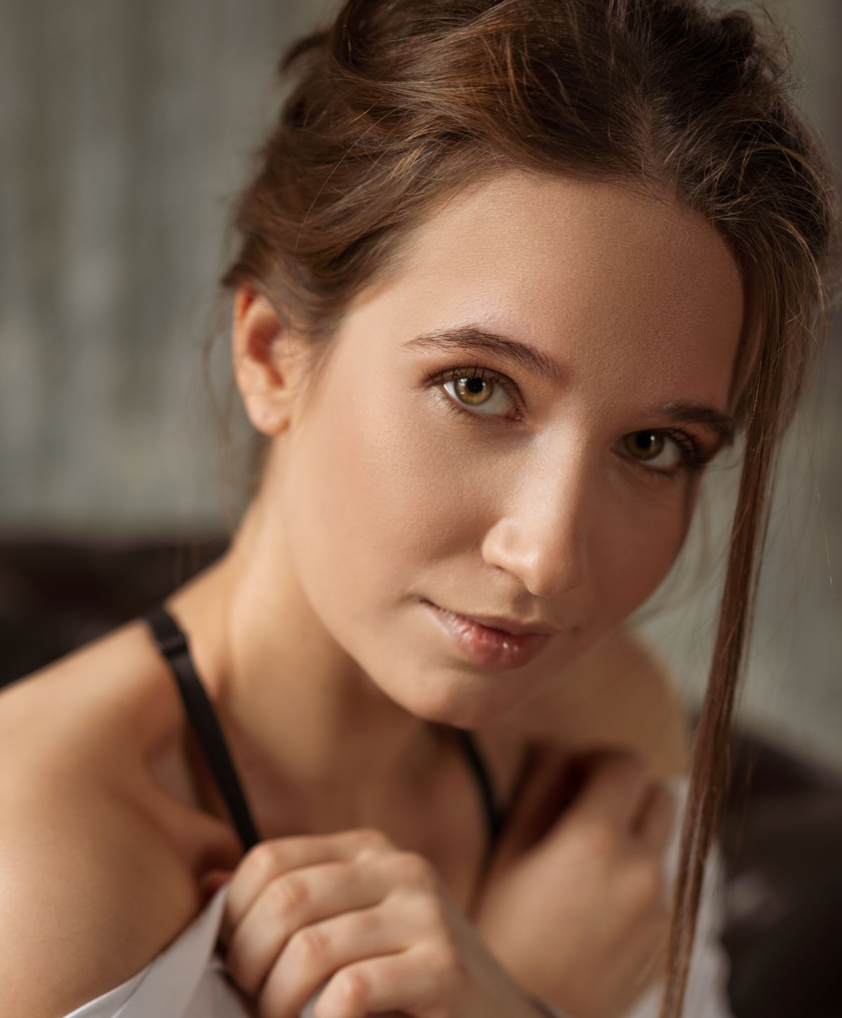 Woman with gentle expression and natural makeup.