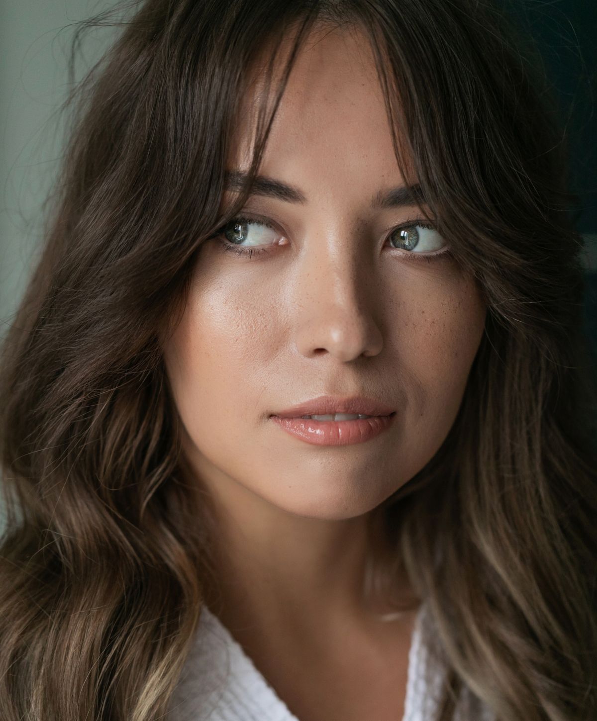 Orange County lines, wrinkles and crepey skin treatment model with long, wavy hair.