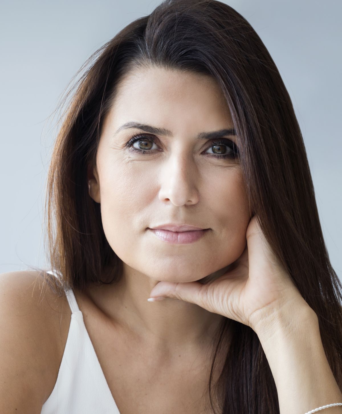 Mission Viejo laser hair removal woman posing thoughtfully with hand on chin.