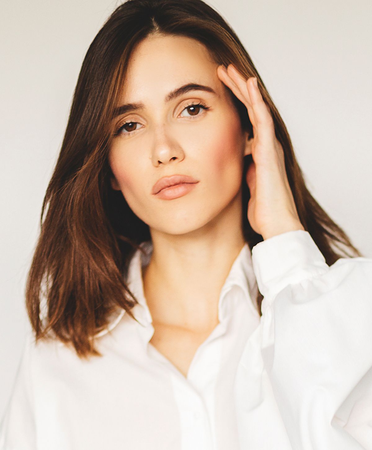 Laguna Hills med spa model with long hair in white shirt.