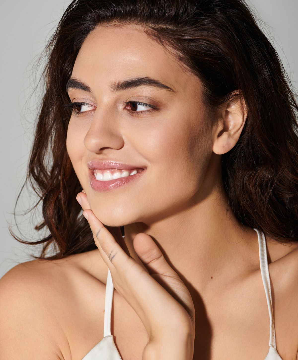 Mission Viejo acne treatments model smiling with soft, natural makeup.