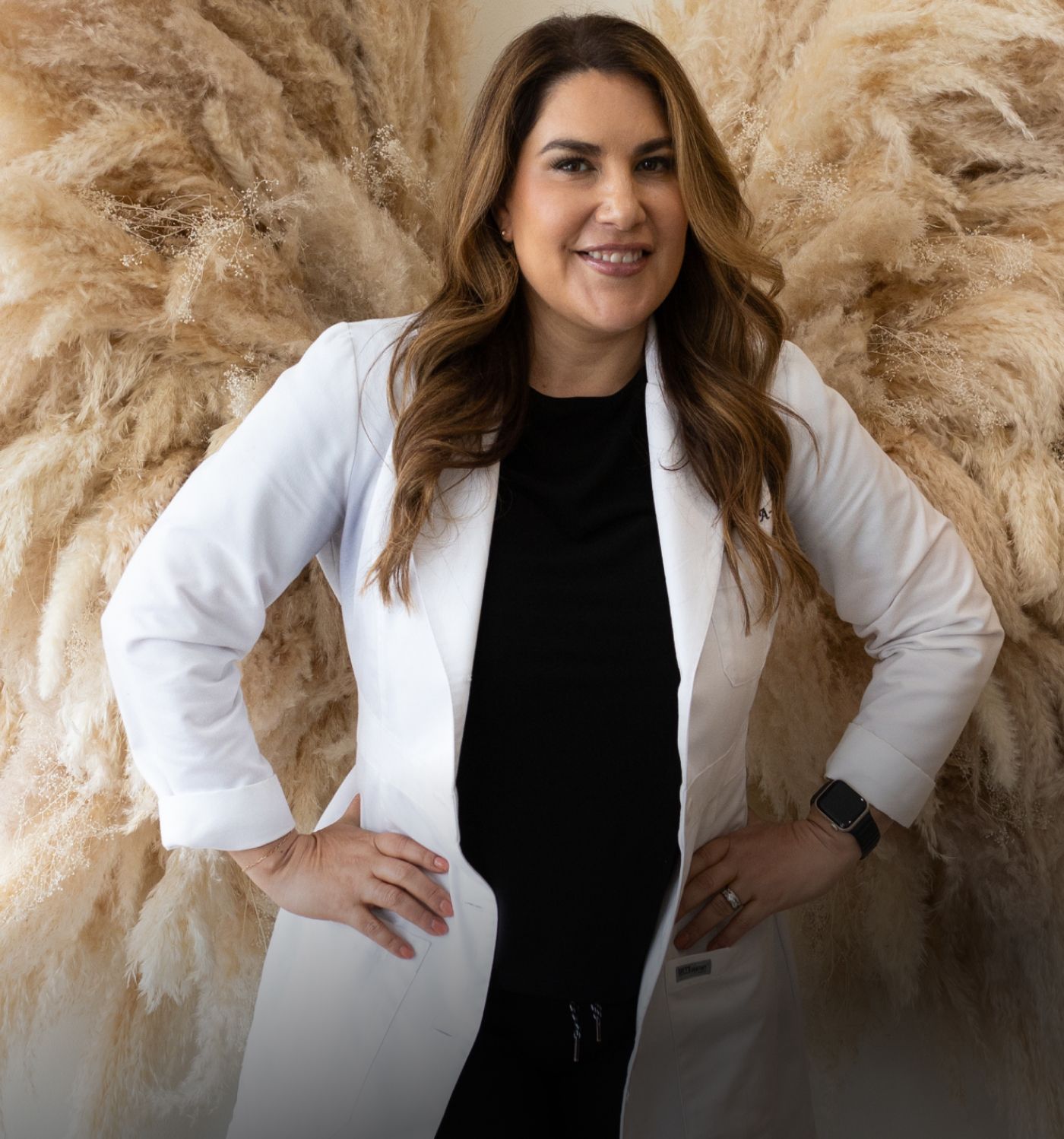 Laguna Hills med spa staff in white lab coat with artistic background.